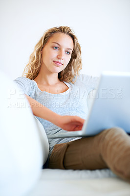 Buy stock photo Sofa, remote work and woman typing on laptop in home, reading email or network on internet. Computer, freelance and girl in living room on social media, online or communication on technology to relax