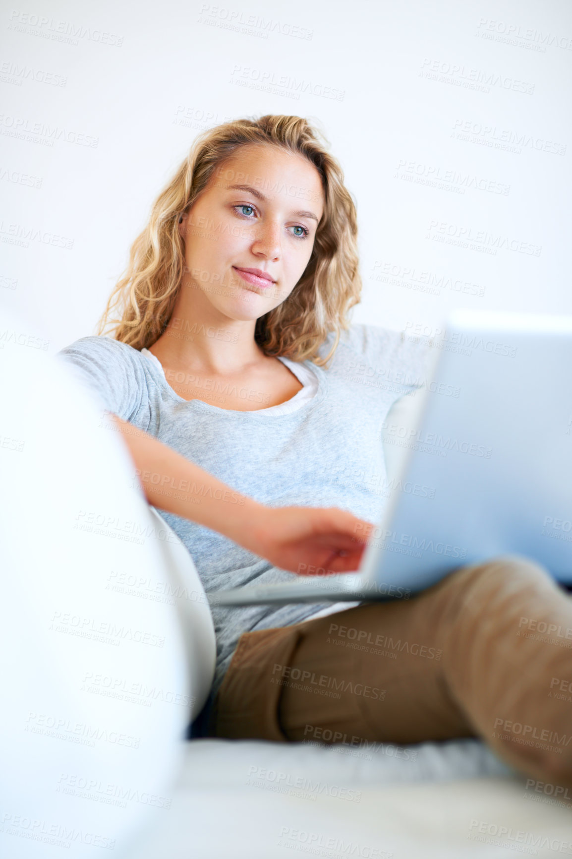 Buy stock photo Sofa, remote work and woman typing on laptop in home, reading email or network on internet. Computer, freelance and girl in living room on social media, online or communication on technology to relax