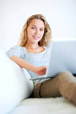 Buy stock photo Laptop, portrait and happy woman on sofa in house, typing email and networking. Computer, smile and person or girl in living room on social media, website and online communication on tech to relax
