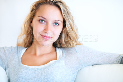 Buy stock photo Woman, natural and beauty portrait on sofa for confident mindset, attractive or white wall background. Female person, face and smile for relax on couch or comfortable, feminine style mockup in Canada