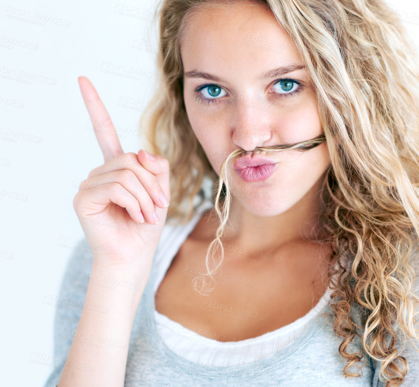 Buy stock photo Woman, portrait and finger or hair mustache, fun confident humor or funny expression. Female person, face emoji or hands pointing on white wall background for playful, silly lips or meme in Canada
