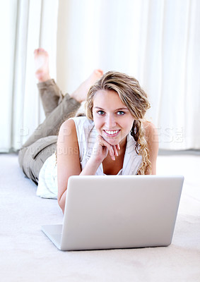 Buy stock photo Laptop, portrait and smile of woman in house on floor, typing email and remote work. Computer, happy and face of person on social media, website or online communication on digital technology to relax