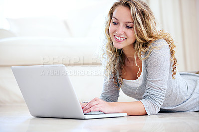 Buy stock photo Laptop, smile and woman typing on floor in home, reading email or network on internet. Computer, happy person and girl in living room on social media, online or communication on digital tech to relax