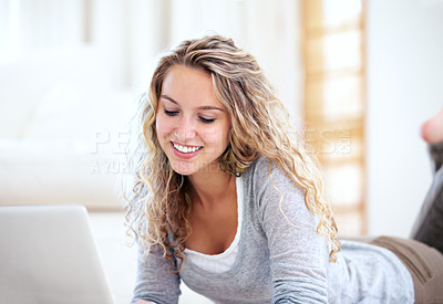 Buy stock photo Laptop, smile and woman typing on floor in home, reading email or network on internet. Computer, happy person and girl in living room on social media, online or communication on digital tech to relax
