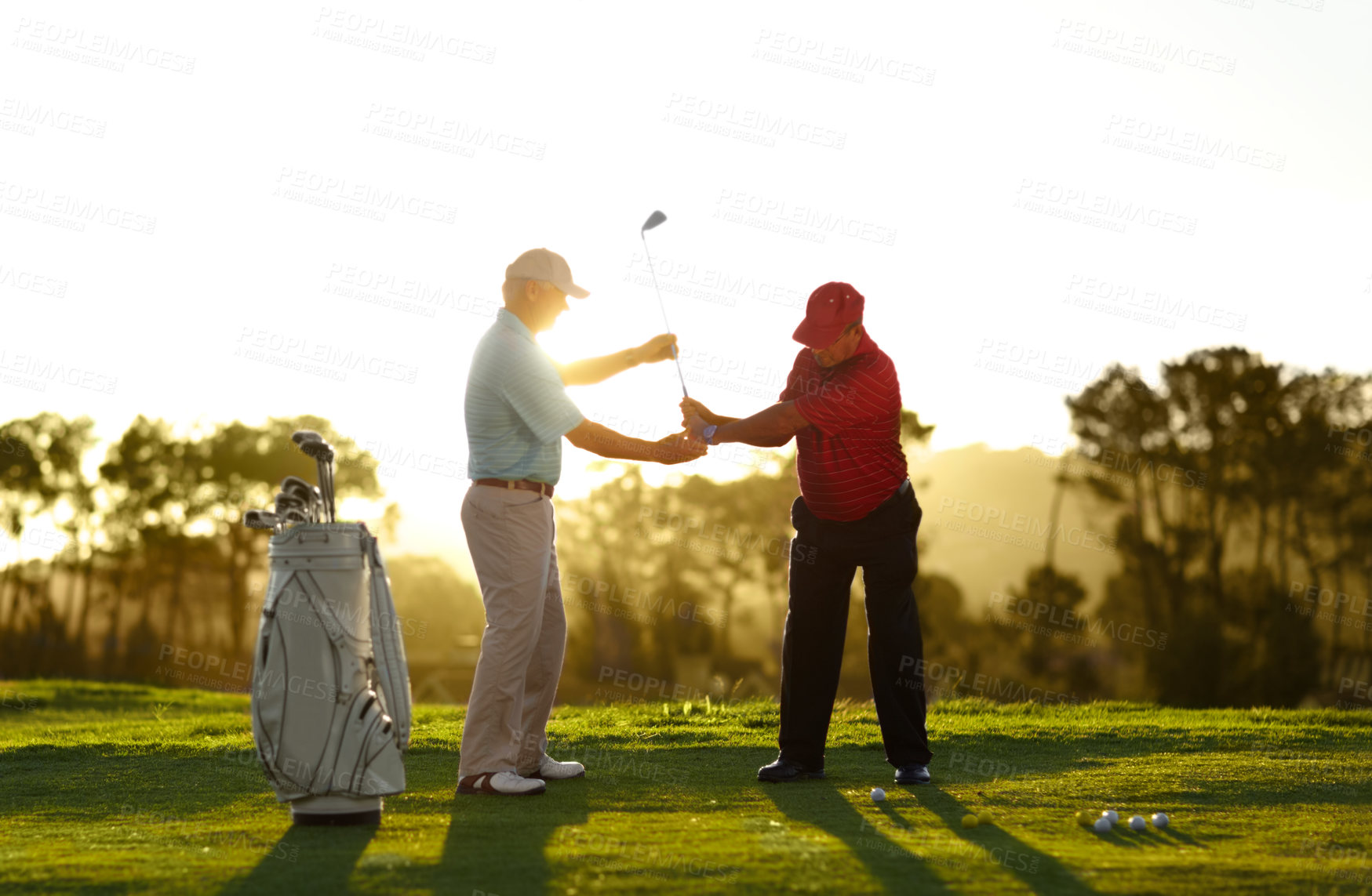 Buy stock photo A male golfer receiving help from his caddy on the golf course