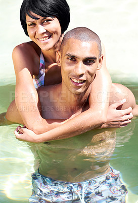 Buy stock photo Portrait of an affectionate young couple in the pool