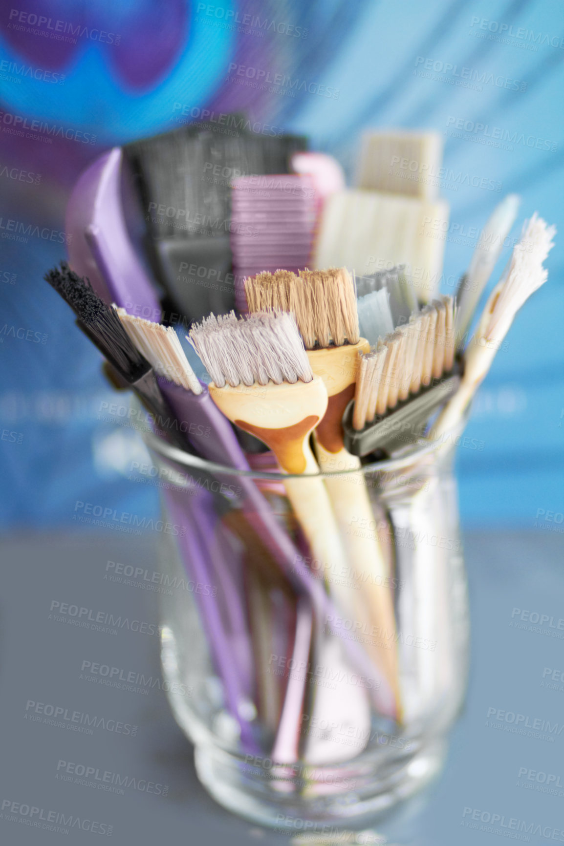 Buy stock photo A glass jar filled with hair colouring brushes