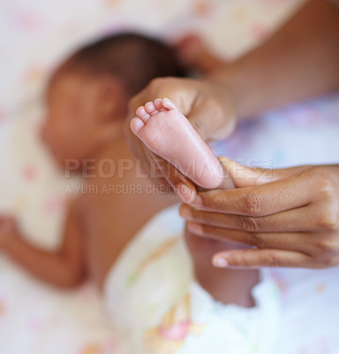 Buy stock photo Hands, infant and closeup of a baby foot with mother holding for comfort, care and love. Childcare, cute and zoom of a woman touching her newborn girl child feet in her crib in the nursery at home.