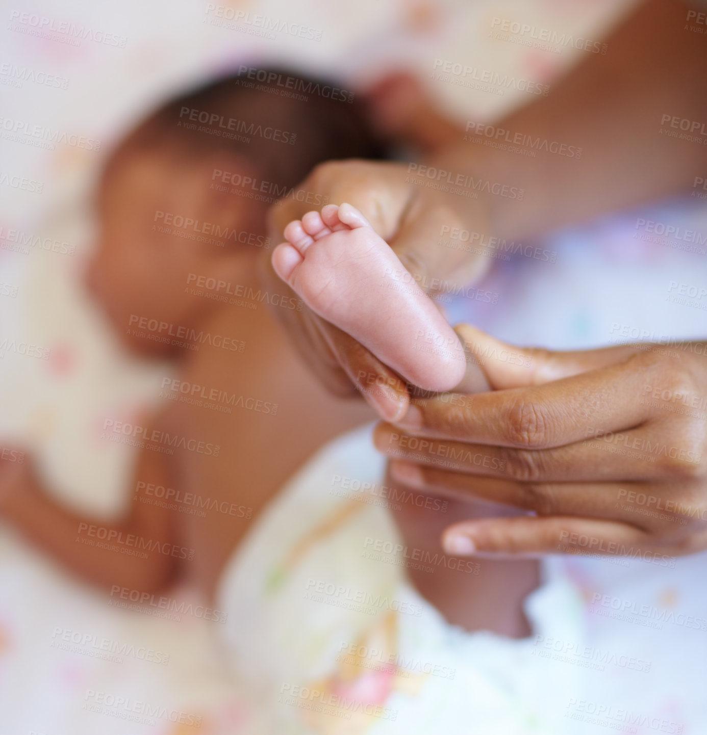 Buy stock photo Hands, infant and closeup of a baby foot with mother holding for comfort, care and love. Childcare, cute and zoom of a woman touching her newborn girl child feet in her crib in the nursery at home.