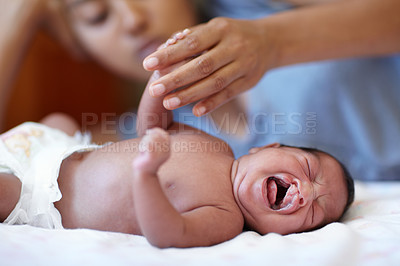 Buy stock photo Newborn, crying and cleft palate with mom, bed and hand holding with parent, sick and family home. Medical issue, syndrome and bedroom for healthcare, childcare and mouth for baby, pain and tired