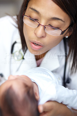 Buy stock photo Healthcare, medicine and a pediatrician with a baby in the hospital for insurance, care or treatment. Medical, kids and a doctor woman holding a newborn infant in a health clinic for an appointment