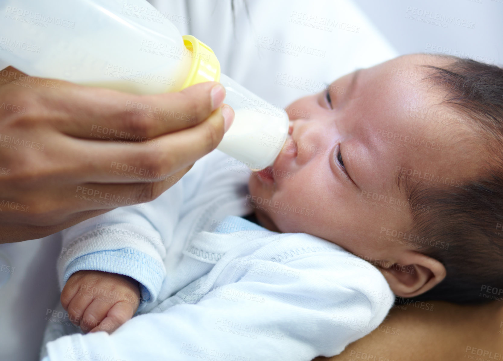 Buy stock photo Baby with cleft lip, milk and mom feeding from bottle for nutrition, health and wellness. Formula, newborn and hand of mother feed child for development, growth or healthy diet, food or lunch at home