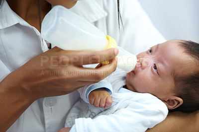 Buy stock photo Shot of a healthcare worker giving formula to an infant who has a cleft palate