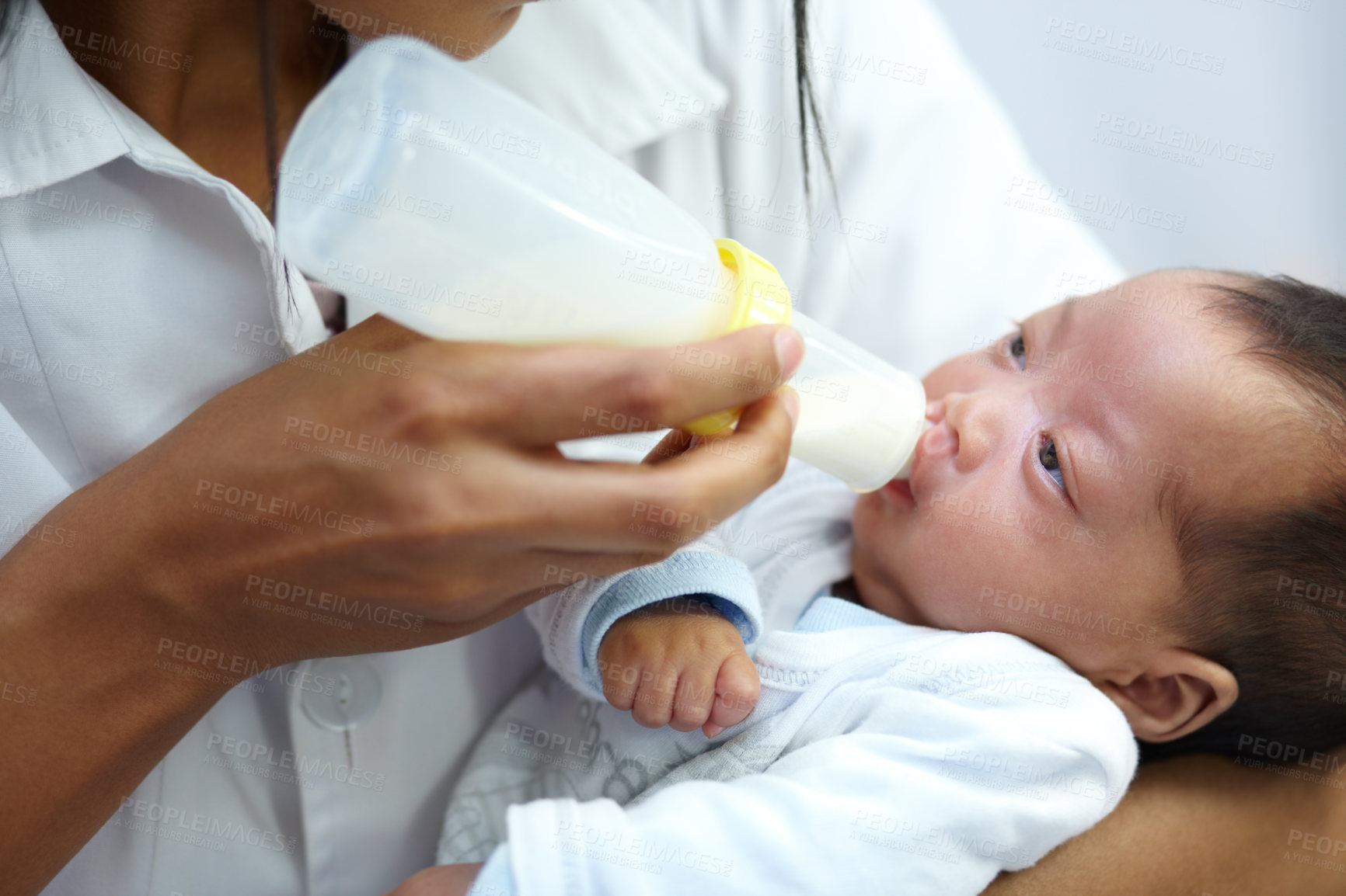 Buy stock photo Shot of a healthcare worker giving formula to an infant who has a cleft palate