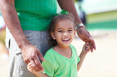 Buy stock photo Portrait, smile and father with girl, holding hands and support with happiness, excited and care. Face, closeup and child with dad, outdoor and kid with joy, summer break and outside with sunshine