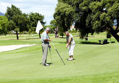 Buy stock photo Man with flag, old woman or golfer on golf course for a birdie, putting stroke or exercise in retirement. Senior couple, mature or serious player training in golfing sports game driving with a club 
