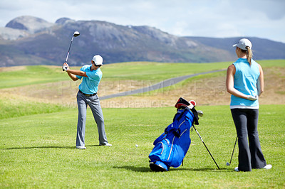 Buy stock photo Swing, man or golfer playing golf for fitness, workout or exercise to drive on a green course. Woman, person golfing or athlete training in action or sports game driving with a club stroke on field