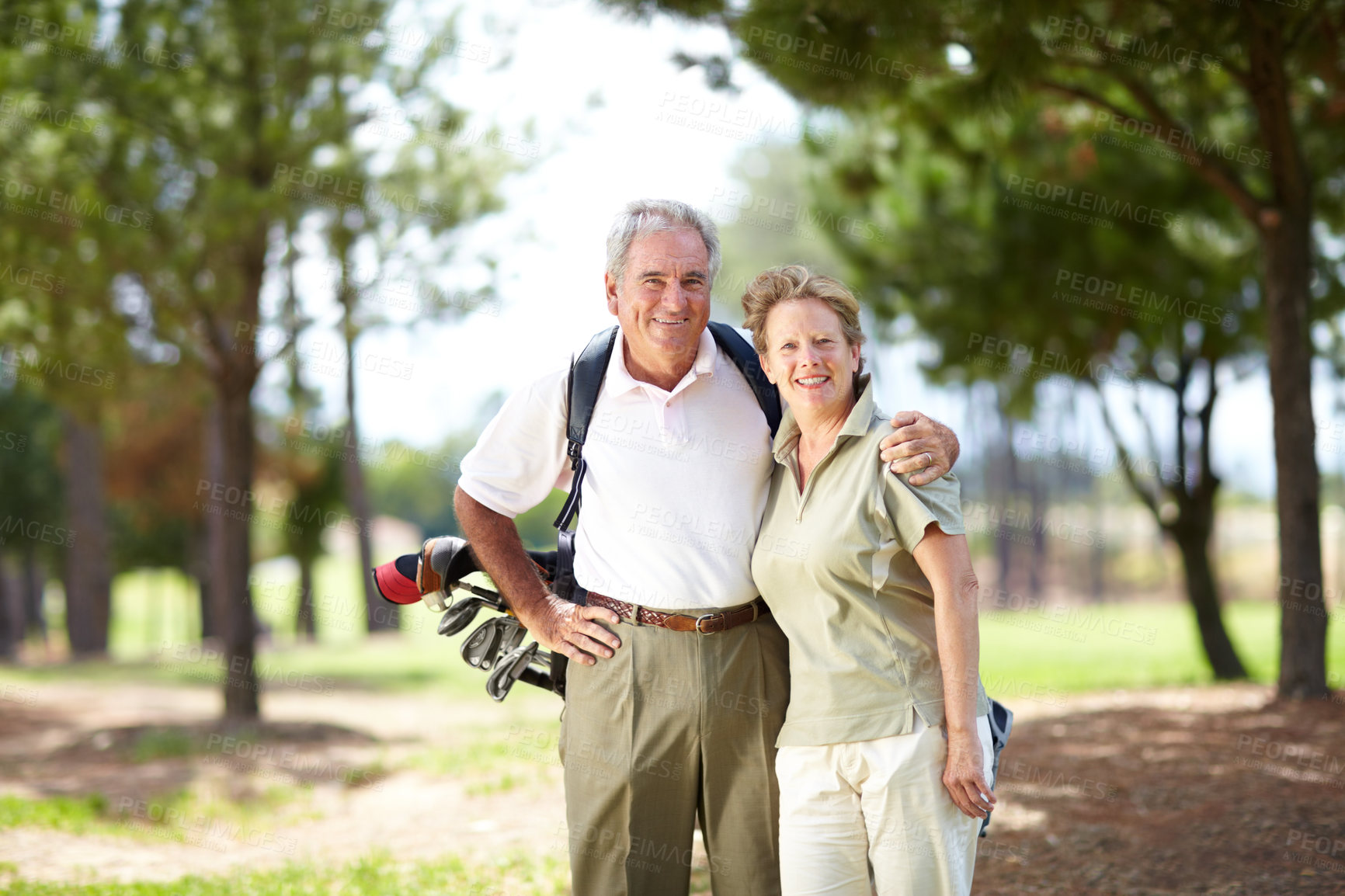 Buy stock photo Portrait of a mature and happy couple embracing during a game of golf