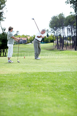 Buy stock photo Old couple, sports or golfer playing golf for fitness, workout or exercise to swing on course or field. Senior woman, elderly man golfing or training in practice game to strike a ball in retirement