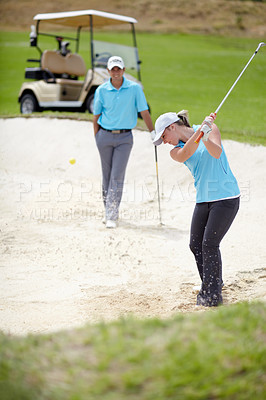 Buy stock photo Golf course, sports and woman golfer playing sport for fitness, workout and exercise with a swing on a sand. Wellness, person and athlete training in action or outdoor game with a club stroke