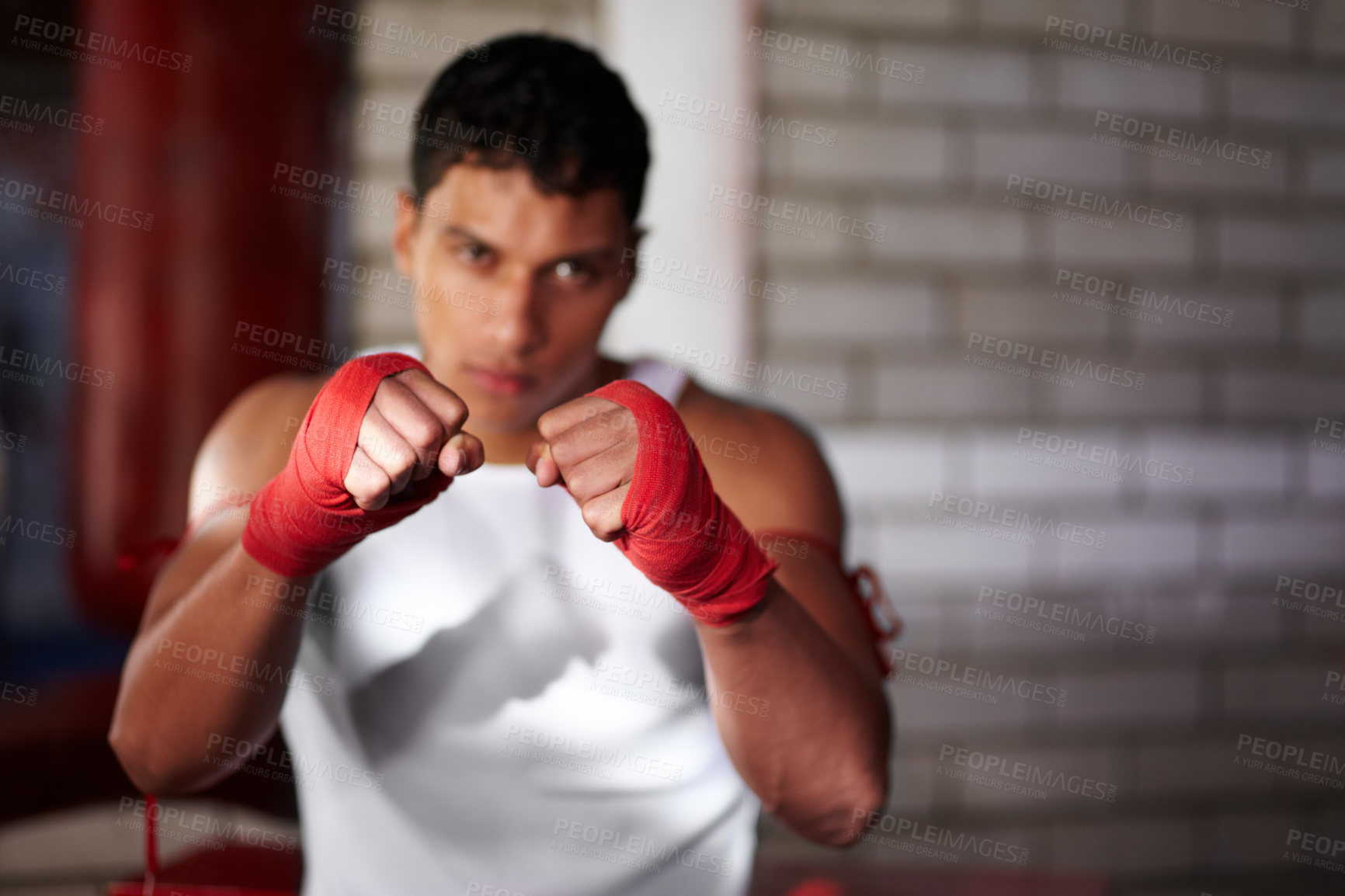 Buy stock photo Fist, portrait and a man at the gym for boxing, fitness or training for a competition. Sports, club and a fighter, boxer or person getting ready for a fight, cardio or a martial arts champion