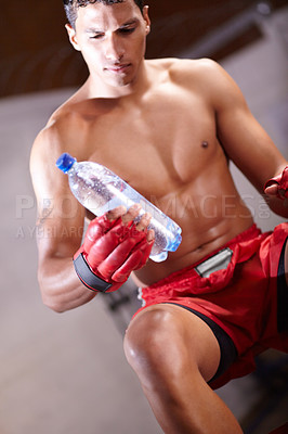 Buy stock photo Boxing, man and bottle of water in gym for health, rest and energy from workout, fitness challenge and training for fight. Strong boxer drinking liquid for hydration, nutrition and power for exercise