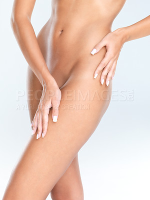 Buy stock photo A studio shot of the torso of a naked model with her hands resting on her hip and thigh