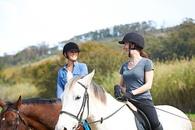 Buy stock photo Women friends, horse riding and talk with smile in helmet, ranger team and equestrian exercise. Girl outdoor together, jockey and chat on adventure, training or learning for contest in countryside