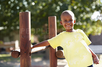 Buy stock photo African boy, portrait and playground at kindergarten, outdoor and sunshine for playing, games and freedom. Child, school garden or park with smile, happy and development in summer, nature or academy