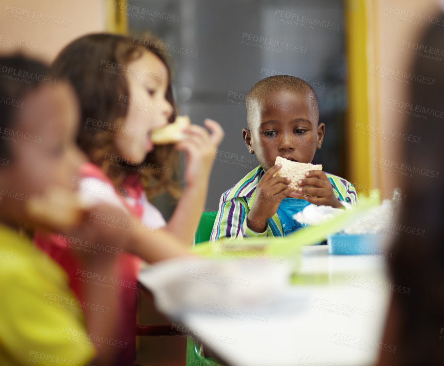 Buy stock photo Eating, boy and children class for lunch at school or creche for an education or to learn. Break, kid and sandwich in a classroom to eat or learning or hungry at desk for nutrition with friends.
