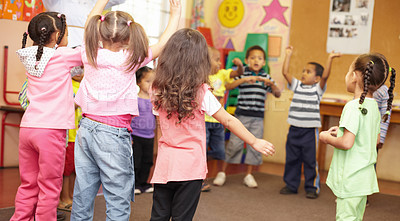 Buy stock photo Preschool students jumping and dancing around having fun