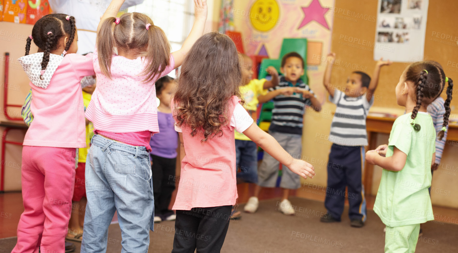 Buy stock photo Preschool students jumping and dancing around having fun