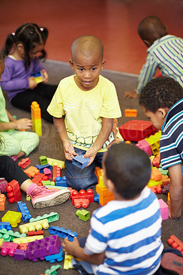 Buy stock photo Play time for a group of young children who are playing with plastic blocks