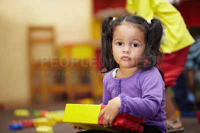 Buy stock photo Learning, building blocks and child portrait in school, classroom and education for kindergarten development. Face of girl or kid playing in creche for mind, motor skills and creative games