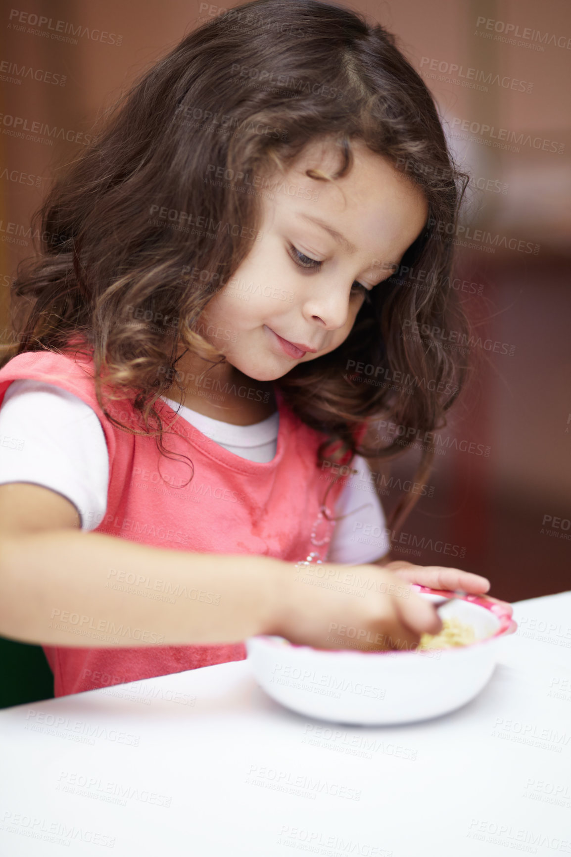 Buy stock photo Girl child, bowl and eating at kindergarten with thinking, nutrition and learning with food on desk. Kid, diet and hungry at table for wellness, health and ideas at lunch, relax and preschool class