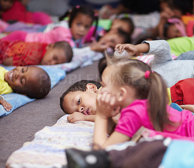 Buy stock photo Preschool children all lying down and getting ready for bed