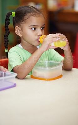 Buy stock photo Drink, juice and girl in kindergarten with food for nutrition at school for learning in class . School, drinks and kid at table in classroom with sandwich for an education to learn at creche.