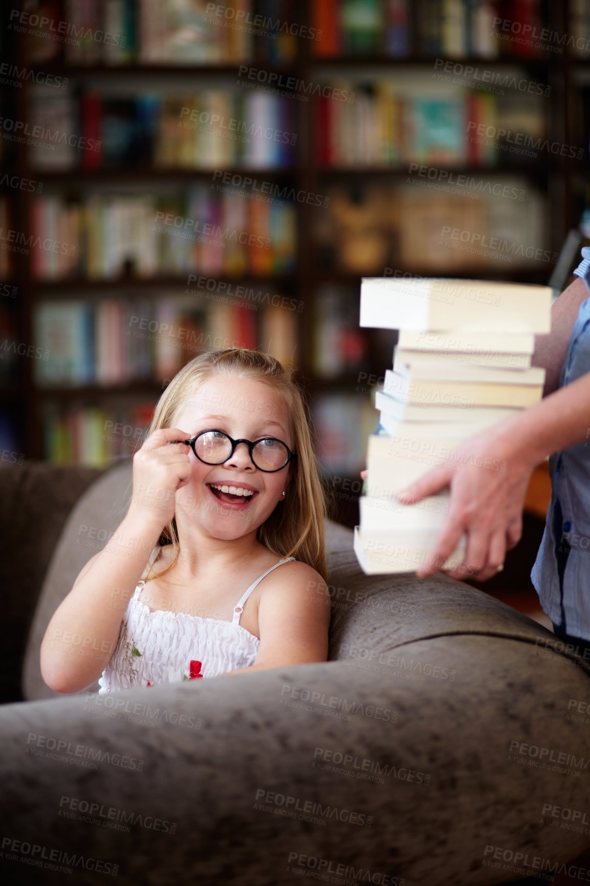Buy stock photo Smile, stack of books and happy child in library, learning and study homework knowledge on couch. School, woman and excited girl with glasses in bookstore together with story,  and education on sofa.