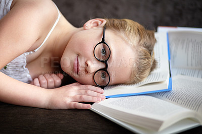 Buy stock photo Portrait, learning and a child reading a book for knowledge, studying or to relax on the floor. Library, young and a girl, kid or a student at school with a novel, story or getting ready for an exam