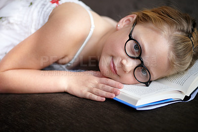 Buy stock photo Portrait, education and a child reading a book for learning, studying or to relax on the floor. Library, young and a girl, kid or a student at school with a novel, story or getting ready for an exam