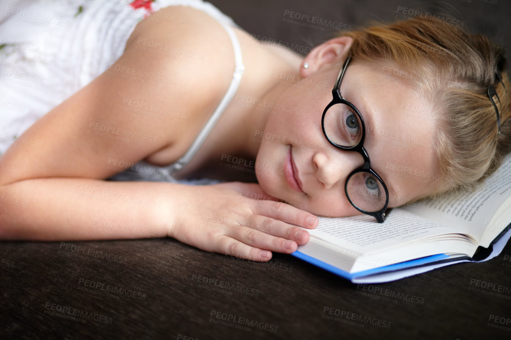 Buy stock photo Portrait, education and a child reading a book for learning, studying or to relax on the floor. Library, young and a girl, kid or a student at school with a novel, story or getting ready for an exam