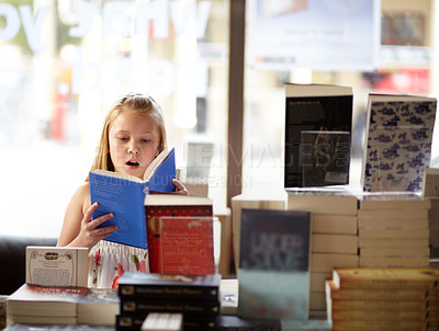 Buy stock photo Reading, books and child in bookshop with shock, learning and surprise with knowledge in shop. Storytelling, girl in bookstore with story, fantasy novel stack and education with imagination in store
