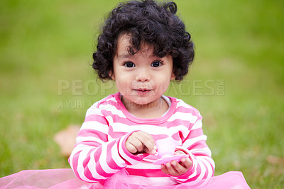 Buy stock photo Nature, smile and portrait of girl child in a garden playing with toy on the grass on summer weekend. Adorable, playful and kid, baby or toddler with curly hair on the lawn in outdoor field or park.
