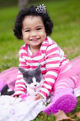 Buy stock photo Portrait, picnic and a girl in the park with her kitten together for love, care or bonding during summer. Smile, cat or kids and a happy young child in the garden having fun with her pet animal