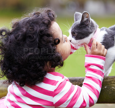 Buy stock photo Shot of a cute little girl kissing her kitten