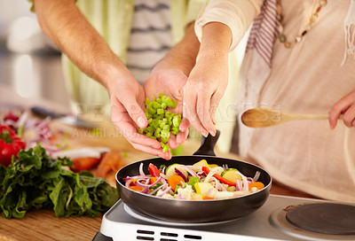 Buy stock photo Cropped image of a married couple cooking in the kitchen
