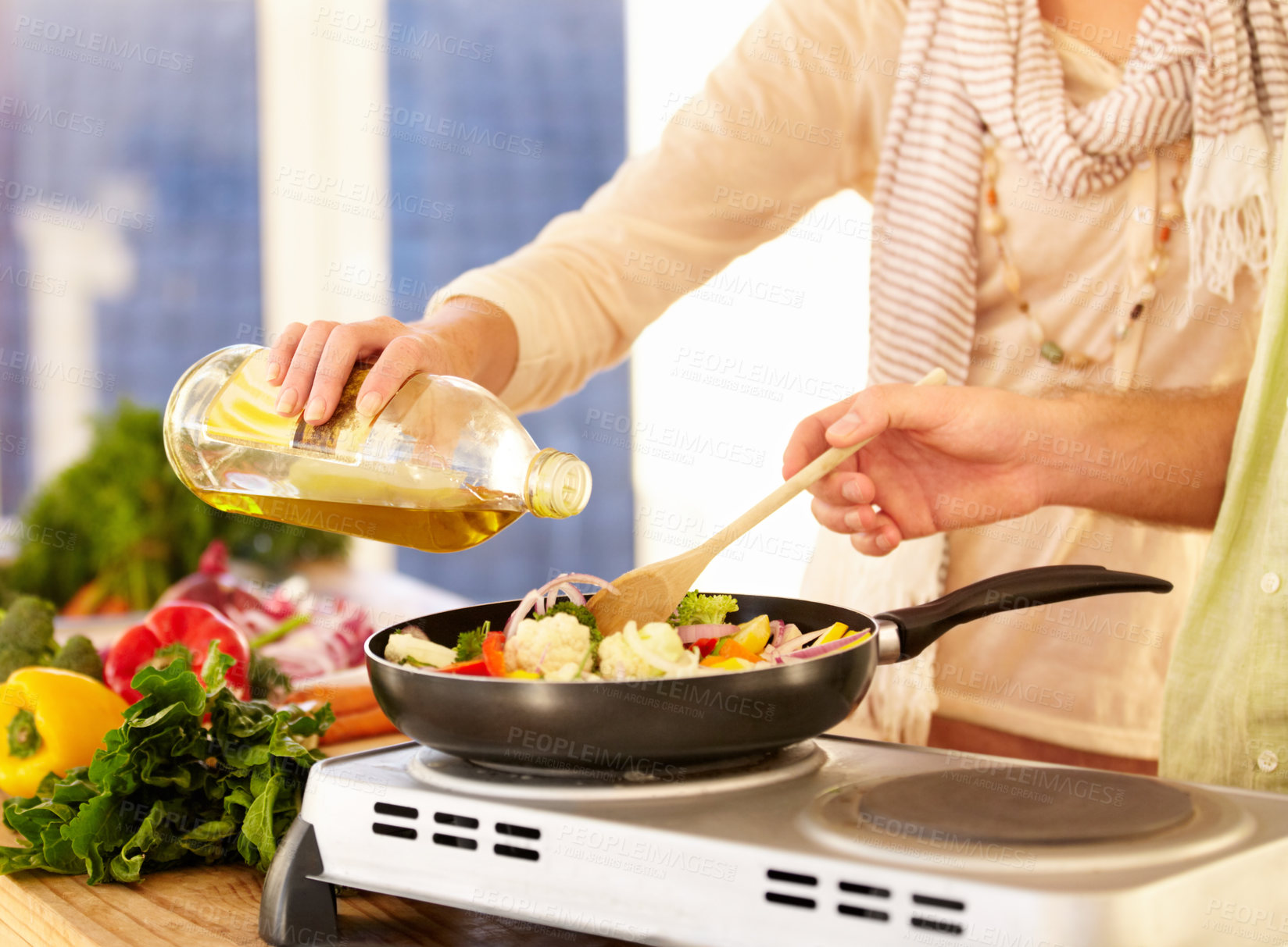 Buy stock photo Cropped image of a couple preparing dinner in the kitchen