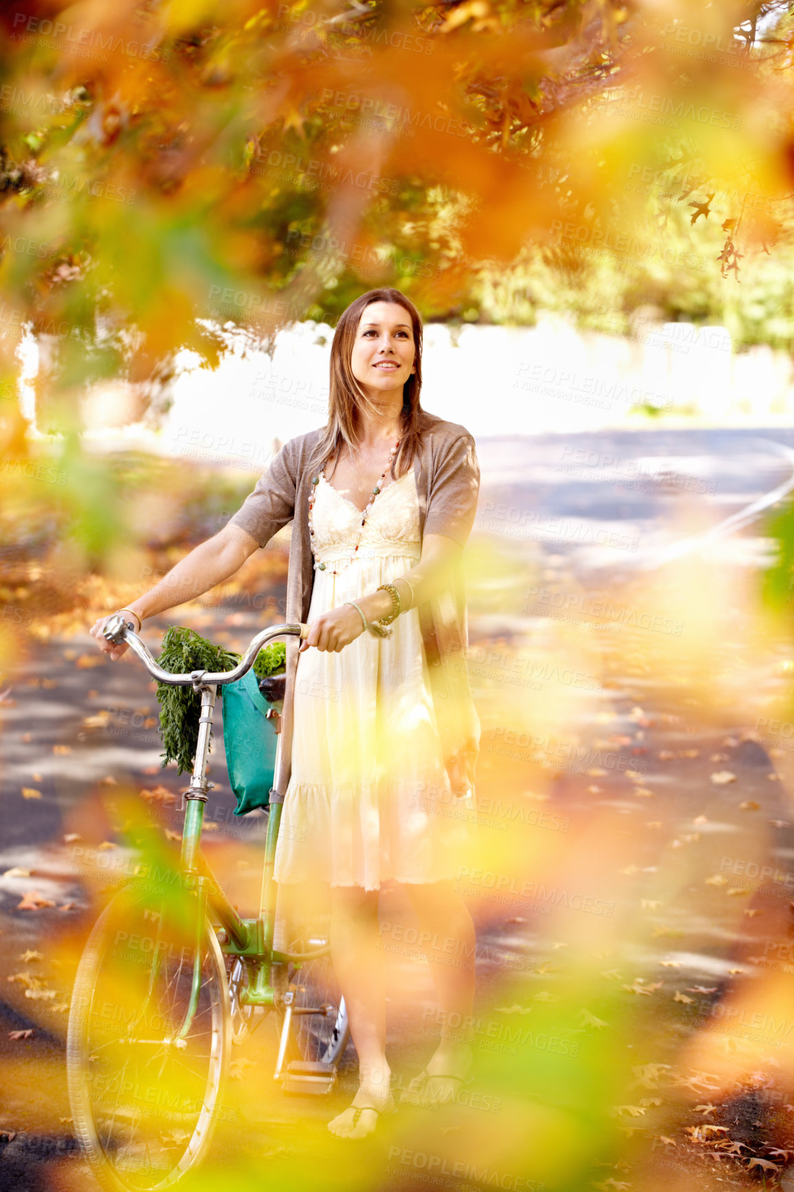 Buy stock photo Shot of an attractive young woman in the park on an autumn day