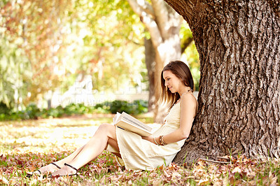 Buy stock photo Woman, book and reading outdoors to relax, peace and calm in nature for travel adventure in New York. Happy female person, freedom and break by tree, literature and fiction in park, story or novel 