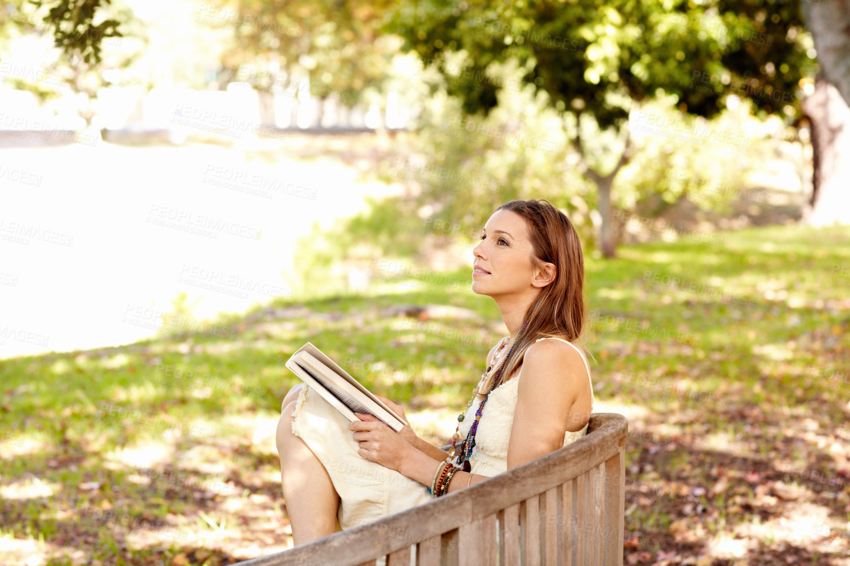 Buy stock photo Shot of an attractive young woman in the park on an autumn day